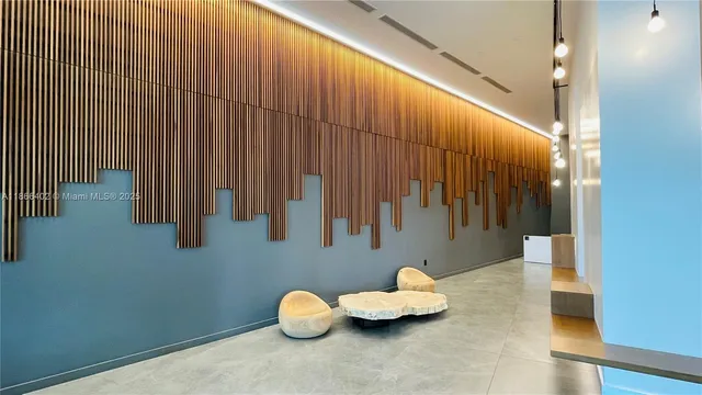 a view of a room with furniture and wooden floor