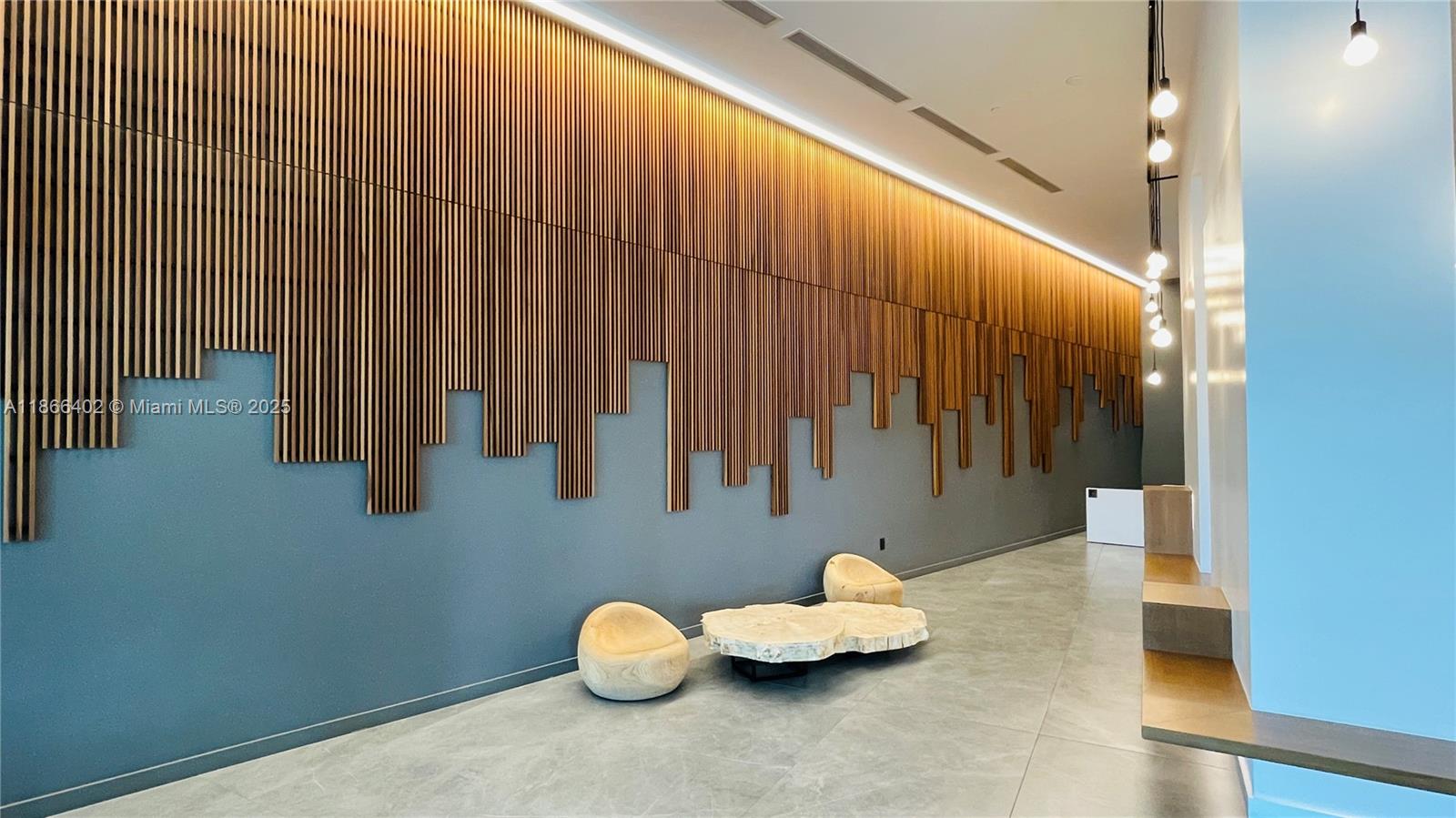 a view of a room with furniture and wooden floor