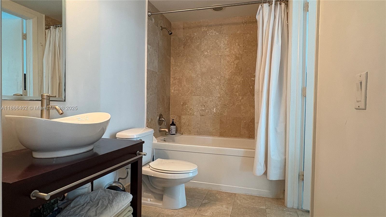 350 South Miami Avenue, Unit 2611 Miami, FL 33130 - Photo 11 of 34 a bathroom with a toilet a sink and a bathtub