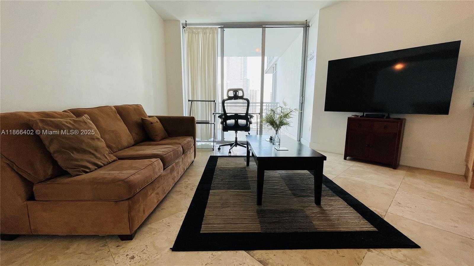350 South Miami Avenue, Unit 2611 Miami, FL 33130 - Photo 5 of 34 a living room with furniture and a flat screen tv