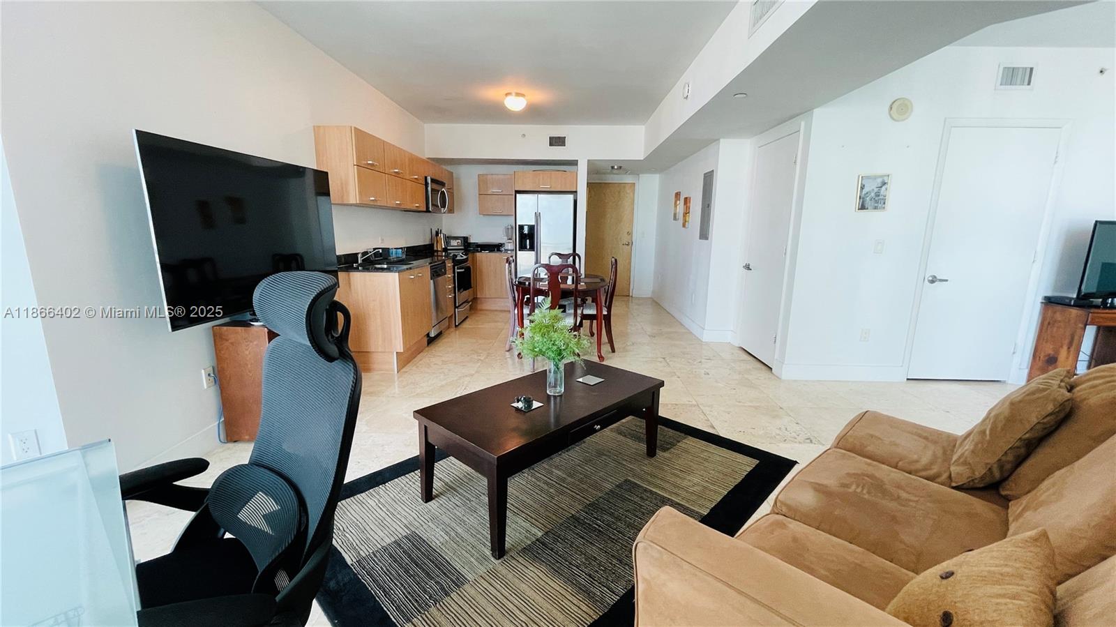 350 South Miami Avenue, Unit 2611 Miami, FL 33130 - Photo 8 of 34 a living room with furniture and a flat screen tv