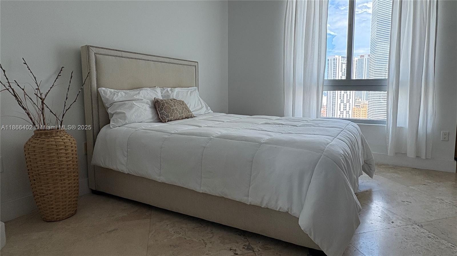 350 South Miami Avenue, Unit 2611 Miami, FL 33130 - Photo 10 of 34 a bed sitting in a bedroom next to a window