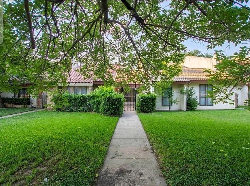 817 West Rochelle Road Irving, TX 75062 - Photo 1 of 21 a front view of a house with a yard and trees