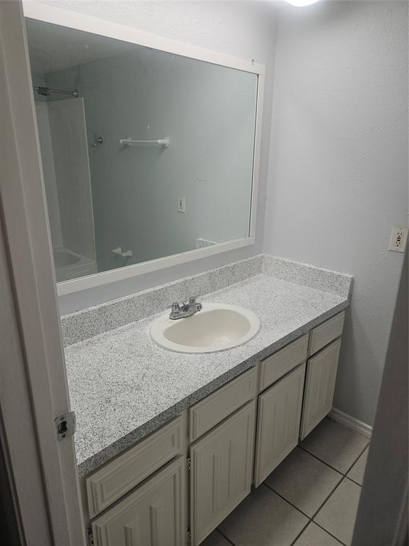 817 West Rochelle Road Irving, TX 75062 - Photo 15 of 21 a bathroom with a granite countertop sink and a mirror