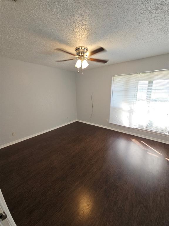 817 West Rochelle Road Irving, TX 75062 - Photo 17 of 21 wooden floor in an empty room with a window