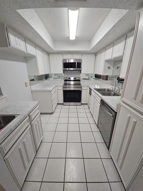 817 West Rochelle Road Irving, TX 75062 - Photo 3 of 21 a kitchen with granite countertop white cabinets a sink dishwasher and a stove top oven