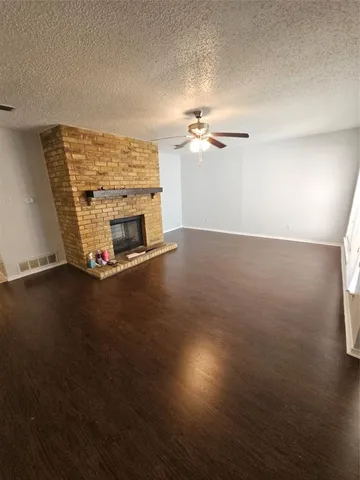 a view of an empty room with a fireplace