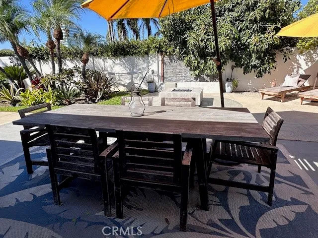 a view of a backyard with table and chairs