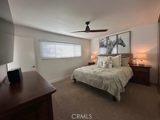 a bedroom with a bed and a desk