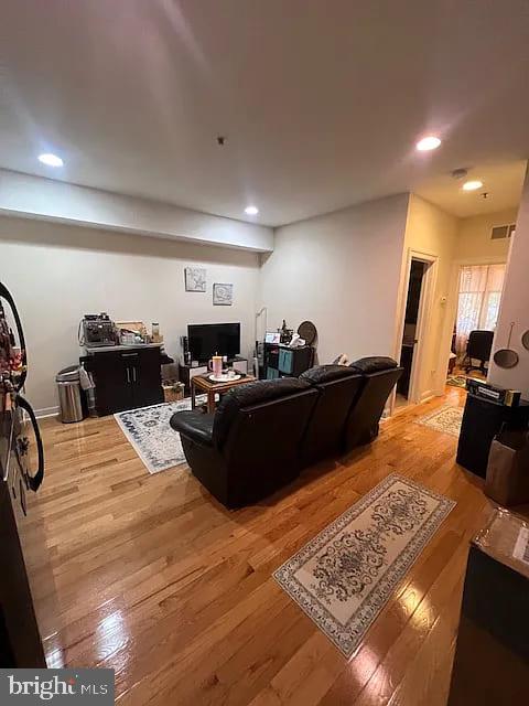 923 North 19th Street, Unit 2R Philadelphia, PA 19130 - Photo 6 of 8 a bed room with furniture and a flat screen tv