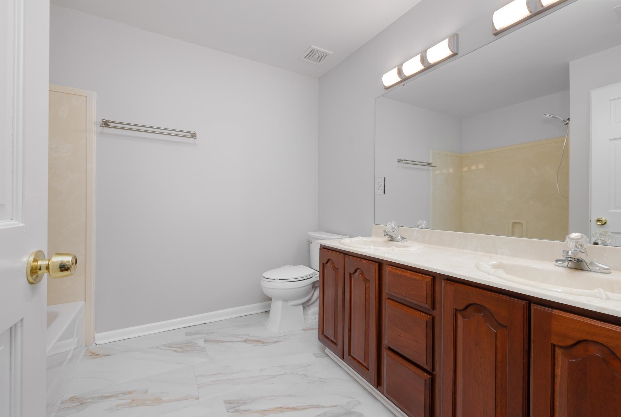 4839 Mayfield Road West Collierville, TN 38017 - Photo 2 of 40 Bathroom with double vanity, light marble finish flooring, and shower combination