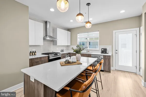 a kitchen with a dining table and chairs