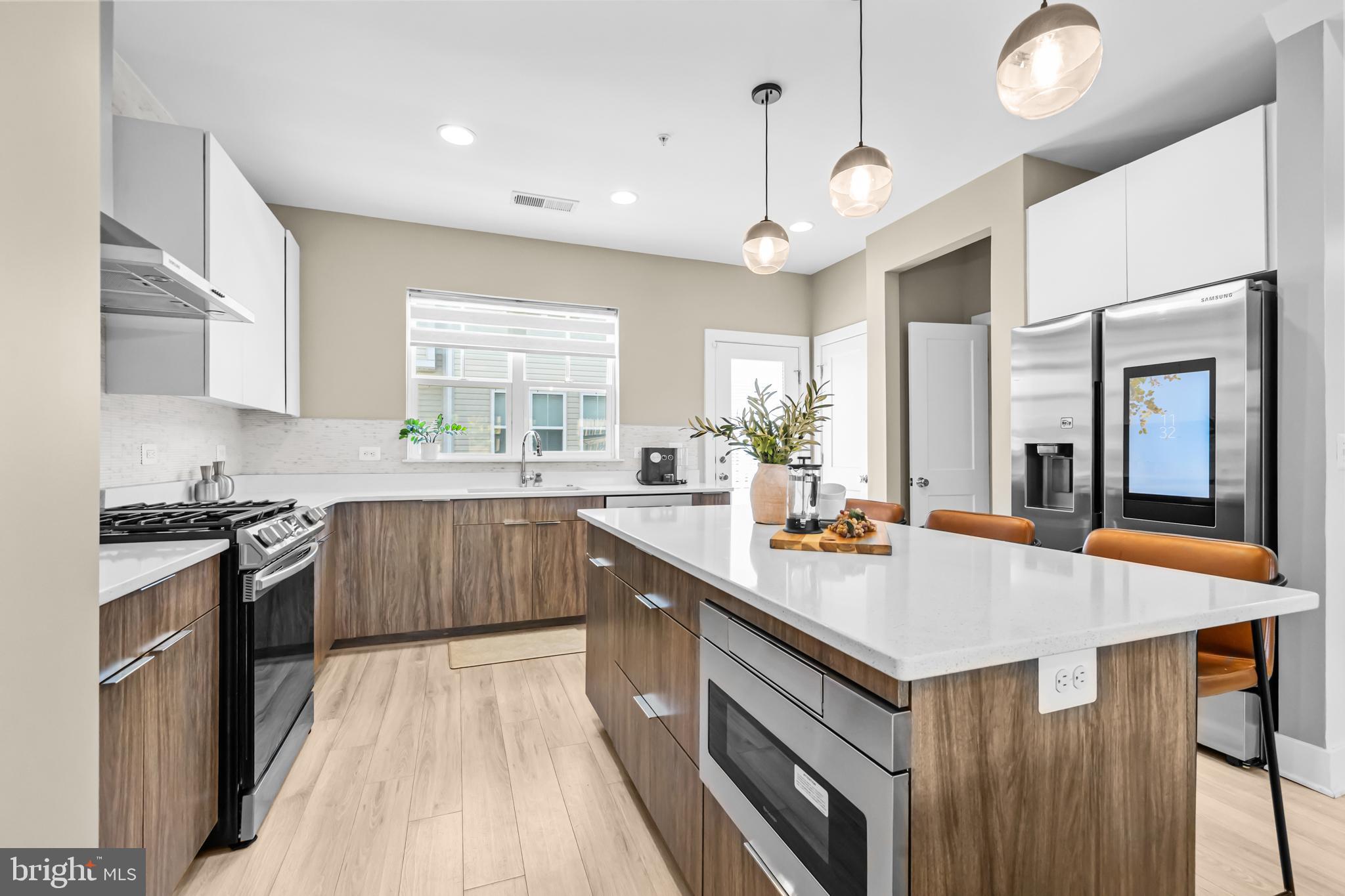 4509 12th Street Northeast Washington, DC 20017 - Photo 13 of 45 a kitchen with stainless steel appliances granite countertop a sink stove and refrigerator