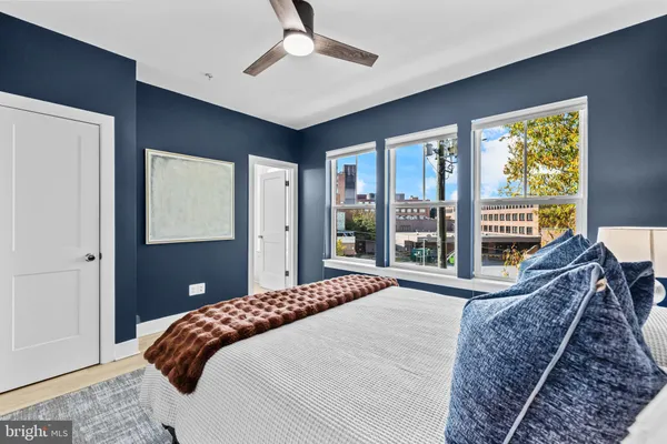 a bedroom with a large bed and a large window