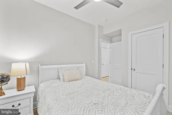 a bedroom with a bed and a lamp