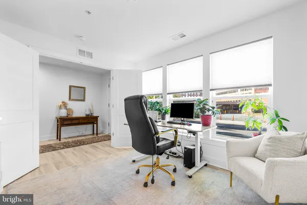a workspace with furniture window and a kitchen