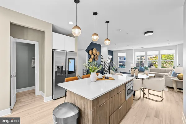 a kitchen that has a table chairs and a wooden floor