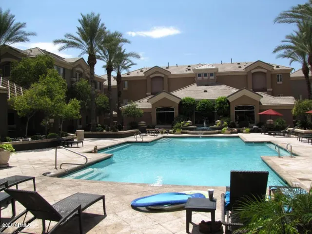 a view of a swimming pool with lounge chairs
