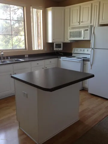 a close view of kitchen countertops with wooden floor and cabinets