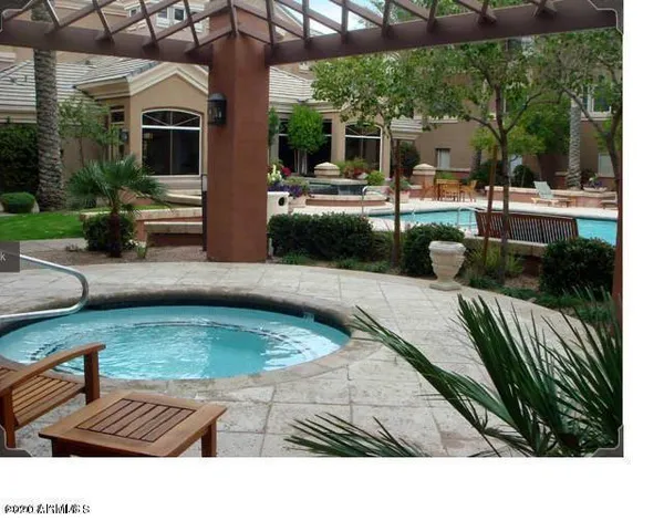 a view of a backyard with swimming pool