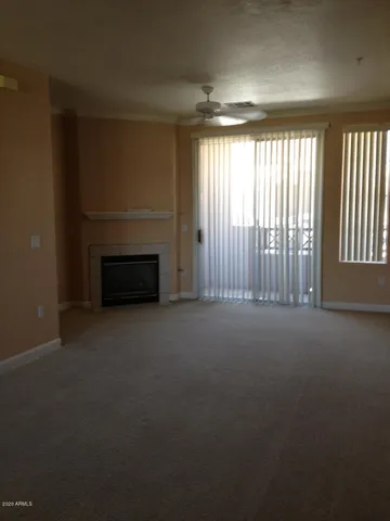 a view of an empty room with a fireplace