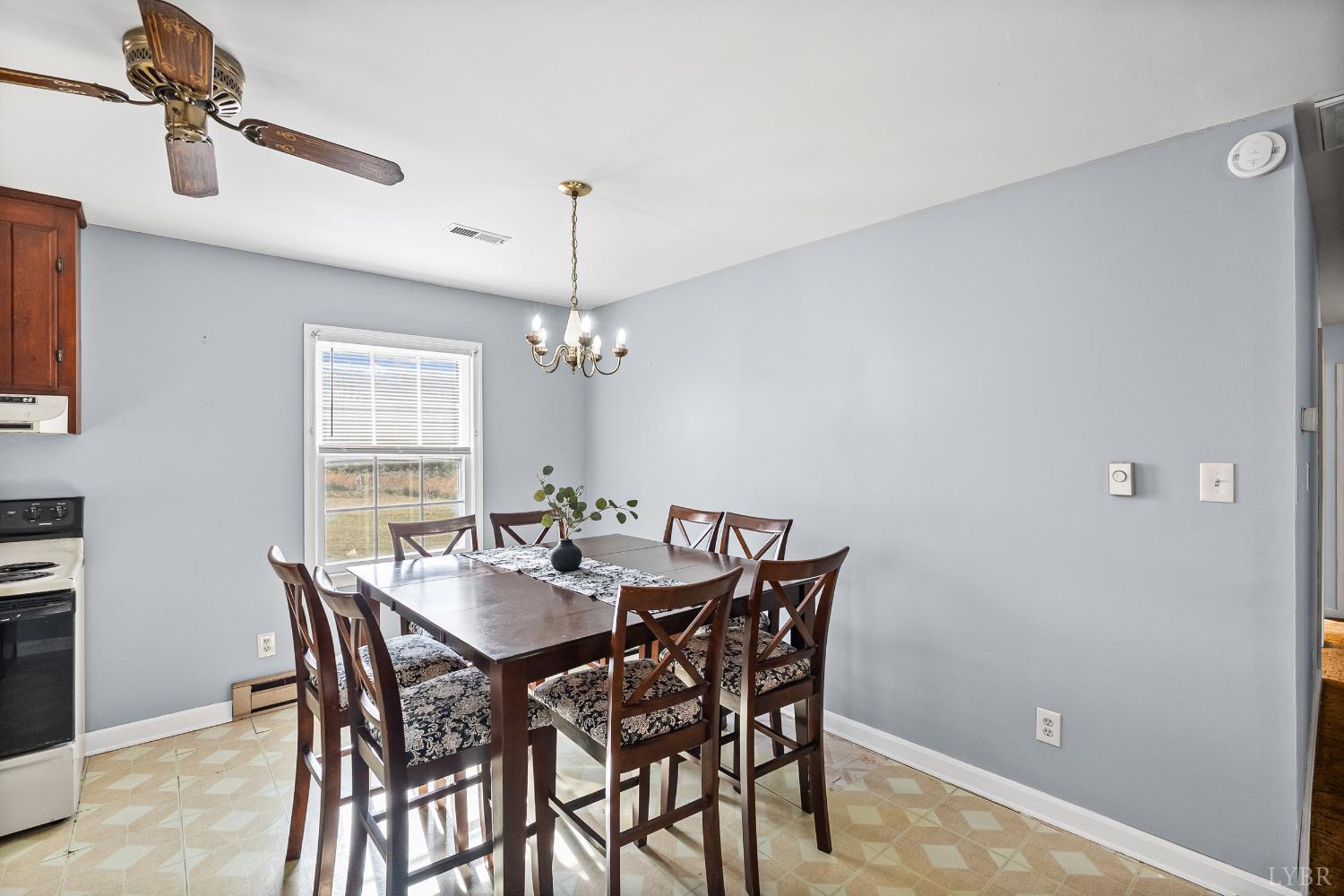 794 Little Dogwood Road Spout Spring, VA 24593 - Photo 12 of 54 a view of a dining room with furniture and chandelier