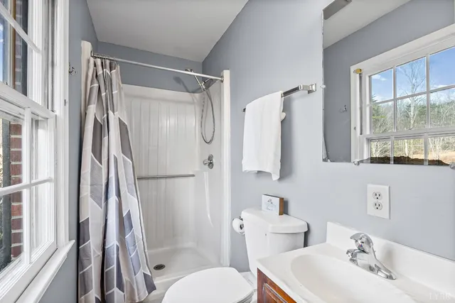 a view of a room with a hanging light and kitchen