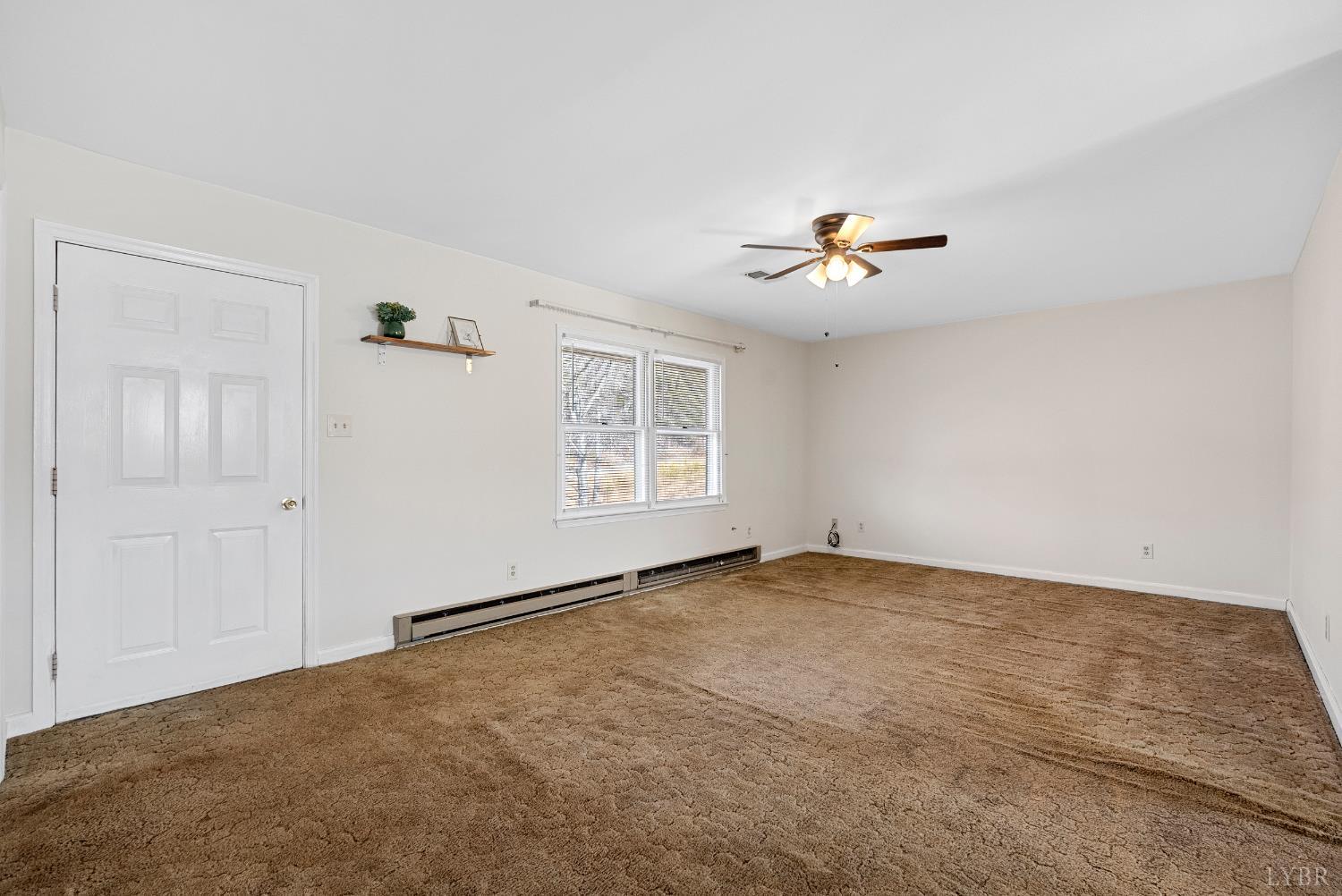 794 Little Dogwood Road Spout Spring, VA 24593 - Photo 5 of 54 an empty room with an empty space and a ceiling fan