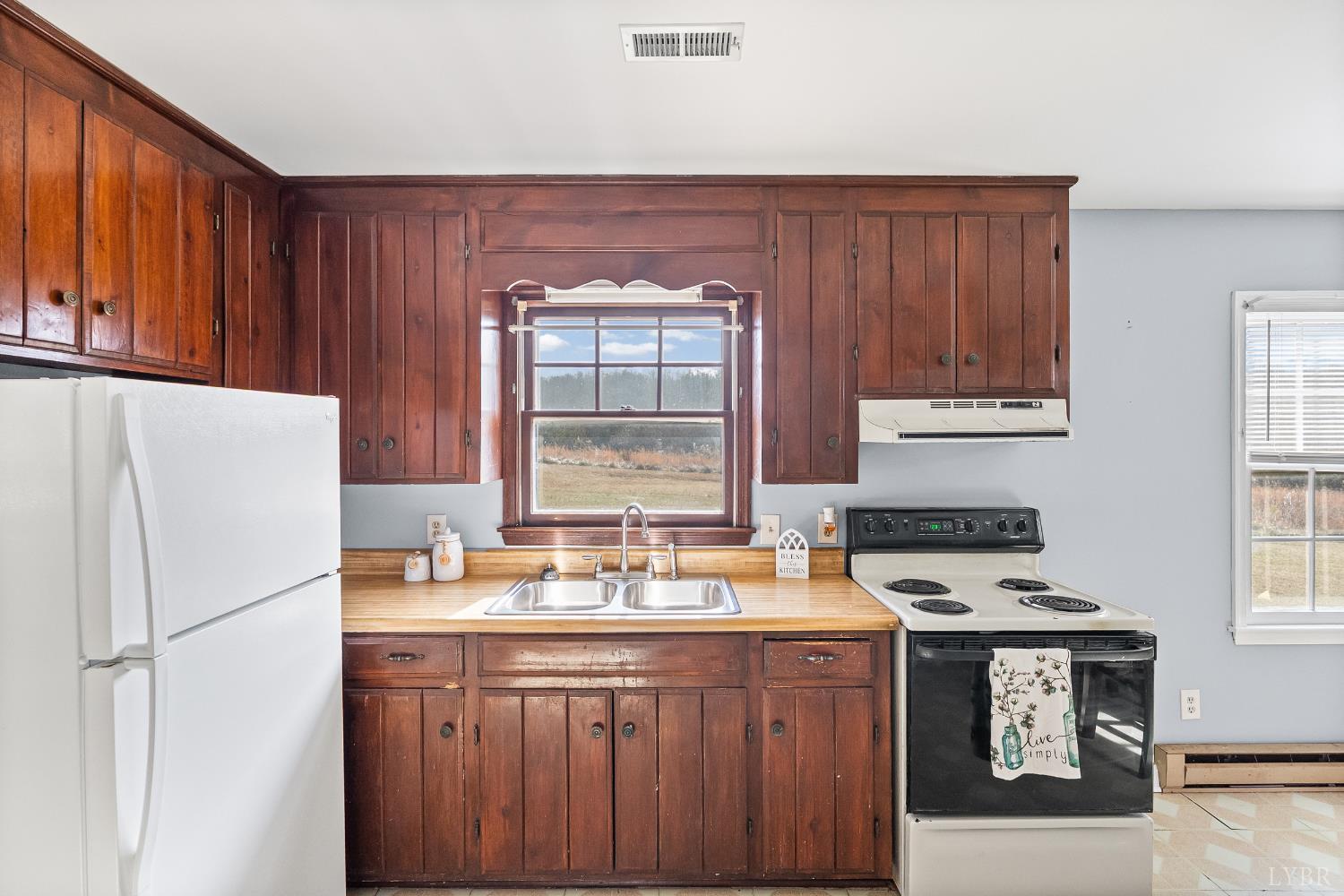 794 Little Dogwood Road Spout Spring, VA 24593 - Photo 9 of 54 a kitchen with stainless steel appliances a refrigerator a stove a sink and a cabinets