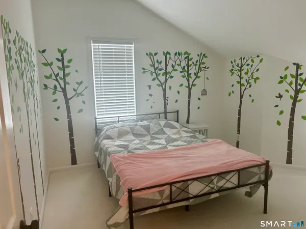 a bedroom with a bed and a table in it