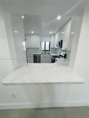 a view of hallway with window and stairs