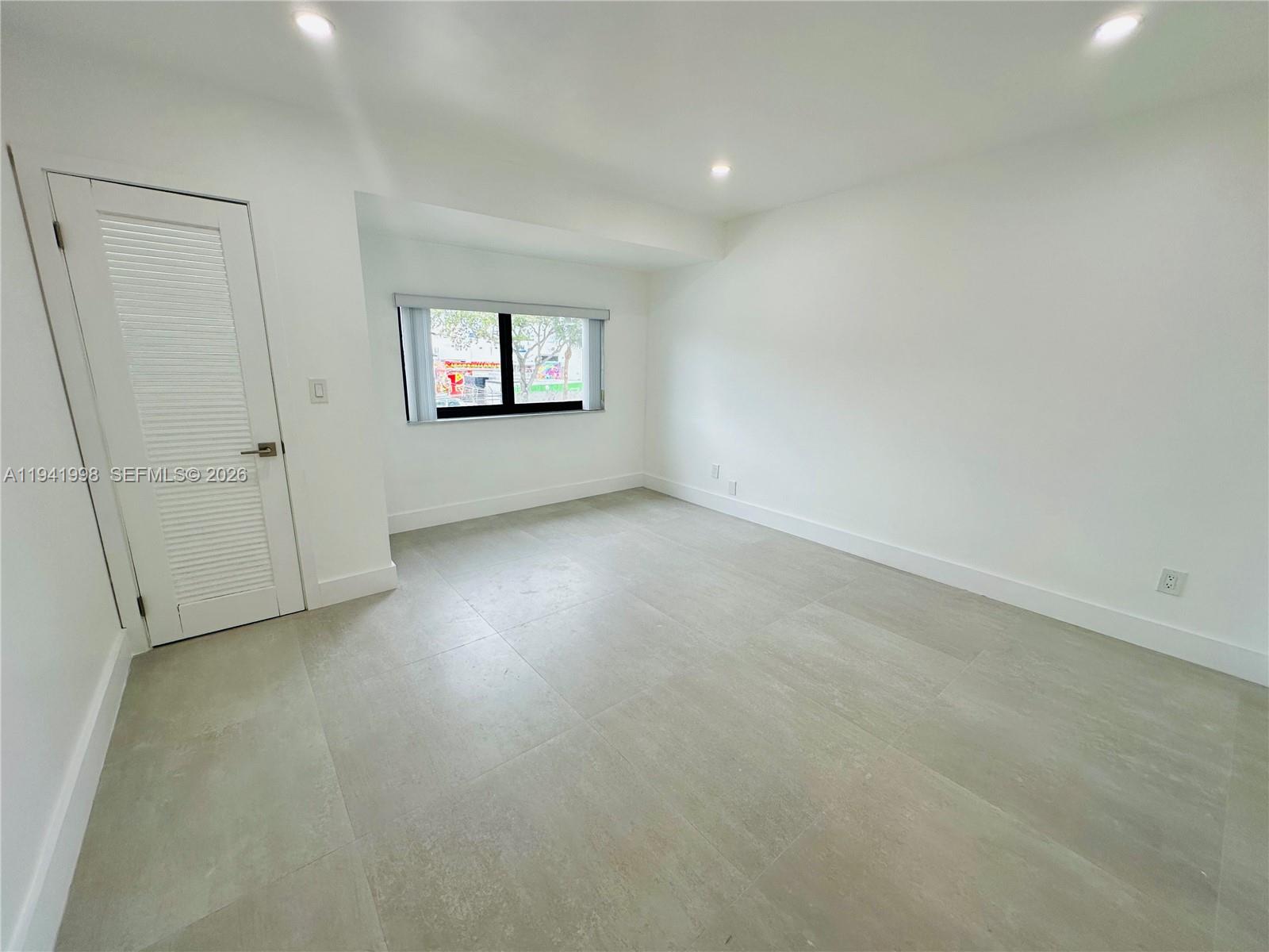 7157 West 19th Court, Unit 7157 Hialeah, FL 33014 - Photo 22 of 40 an empty room with windows and windows