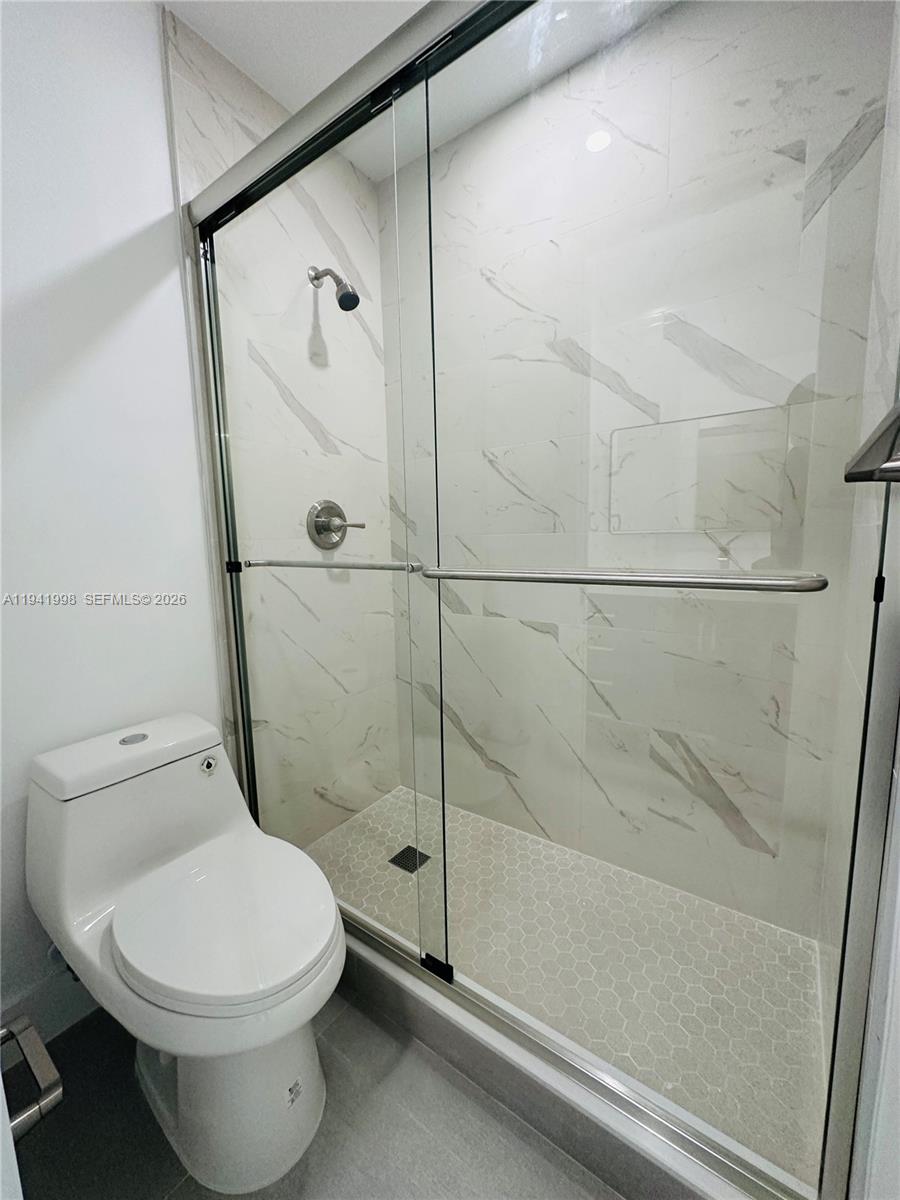 7157 West 19th Court, Unit 7157 Hialeah, FL 33014 - Photo 29 of 40 a bathroom with a toilet and a shower