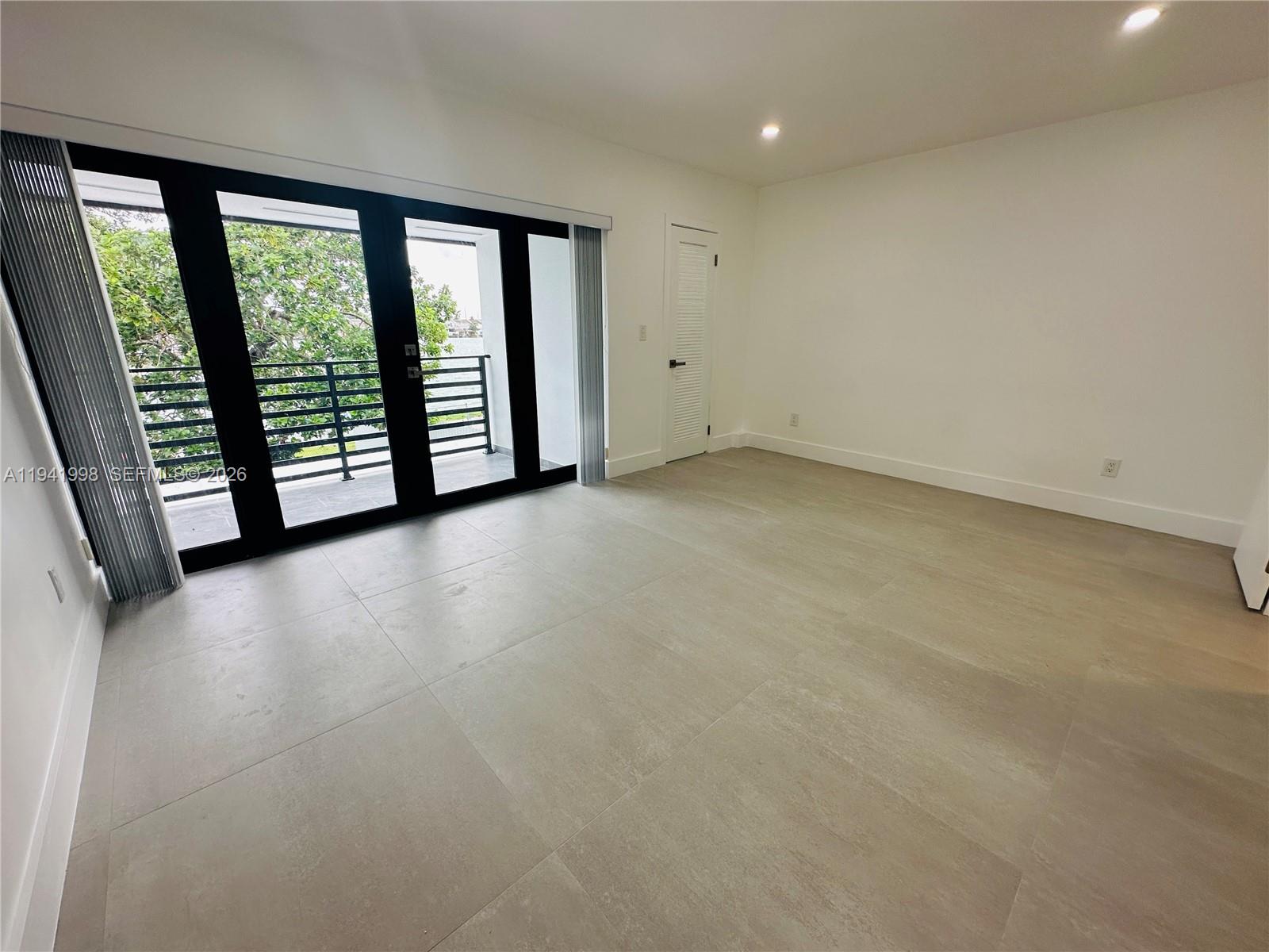 7157 West 19th Court, Unit 7157 Hialeah, FL 33014 - Photo 33 of 40 an empty room with windows