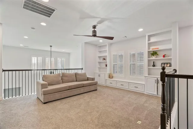 a living room with furniture ceiling fan and a rug
