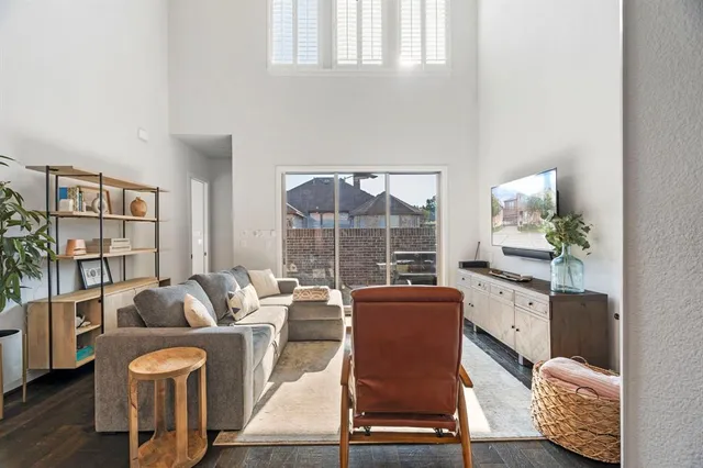a living room with furniture a rug and a large window