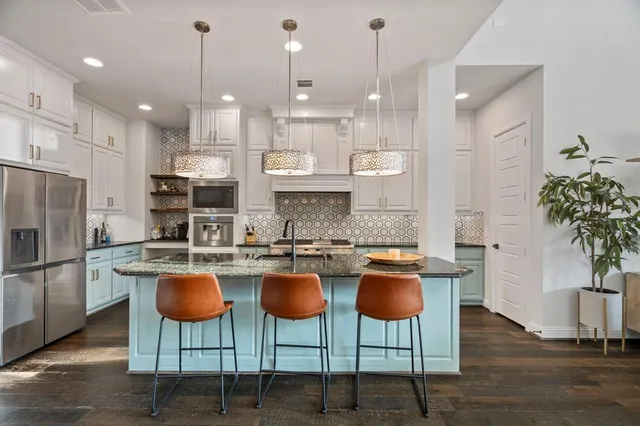 a kitchen with granite countertop a counter space cabinets stainless steel appliances and cabinets