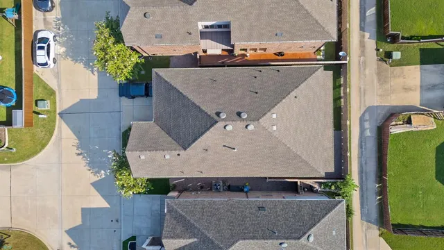 an aerial view of a house with a swimming pool