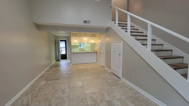 a view of entryway and hall with wooden floor