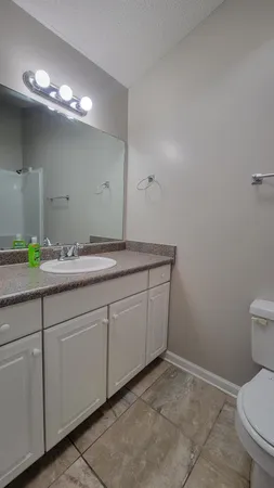 a white toilet sitting next to a bath tub