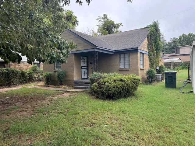 a view of a house with yard and a garden