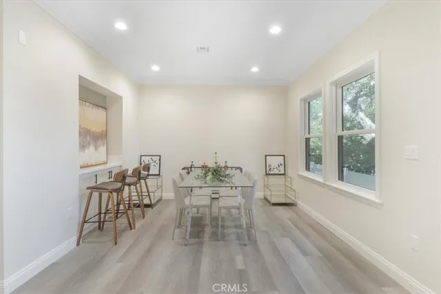a dining room with furniture and wooden floor
