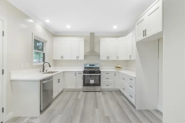 a kitchen with white cabinets appliances and sink