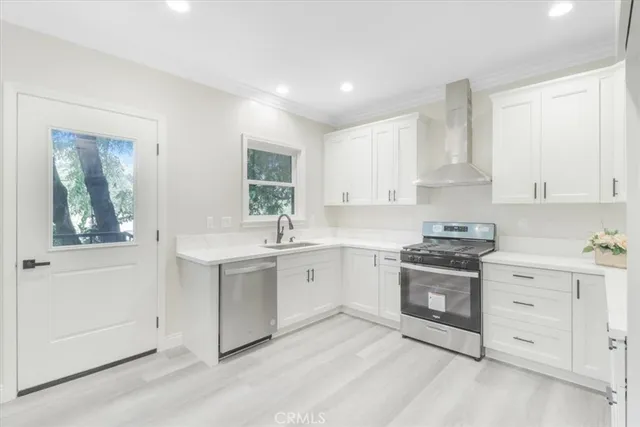 a kitchen with white cabinets and white appliances