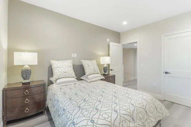 a bedroom with a bed and painting on the wall