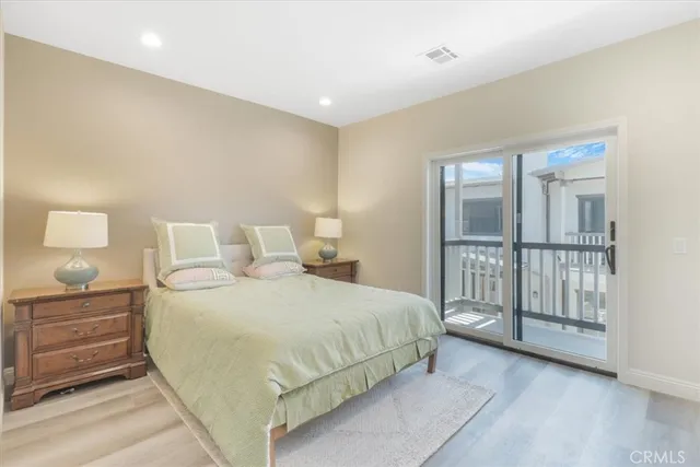 a bedroom with a bed and a night stand