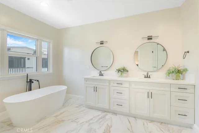 a spacious bathroom with double vanity sink and a mirror