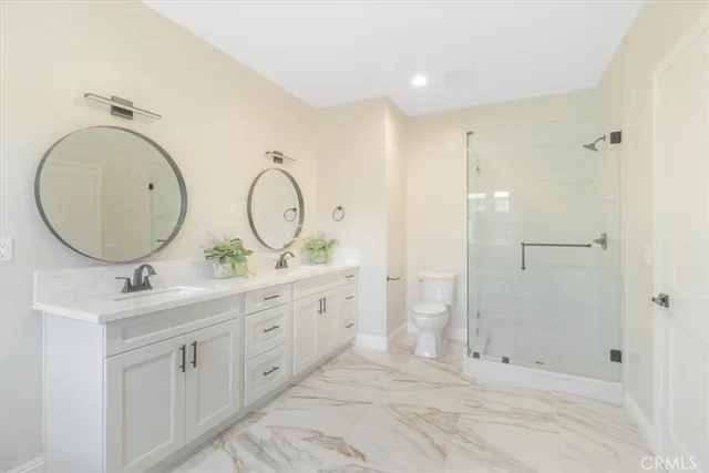 a bathroom with double vanity sink and a mirror