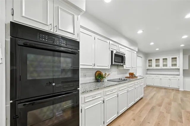 a kitchen with a sink stove and microwave