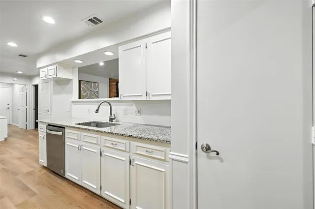 a kitchen with a sink and cabinets